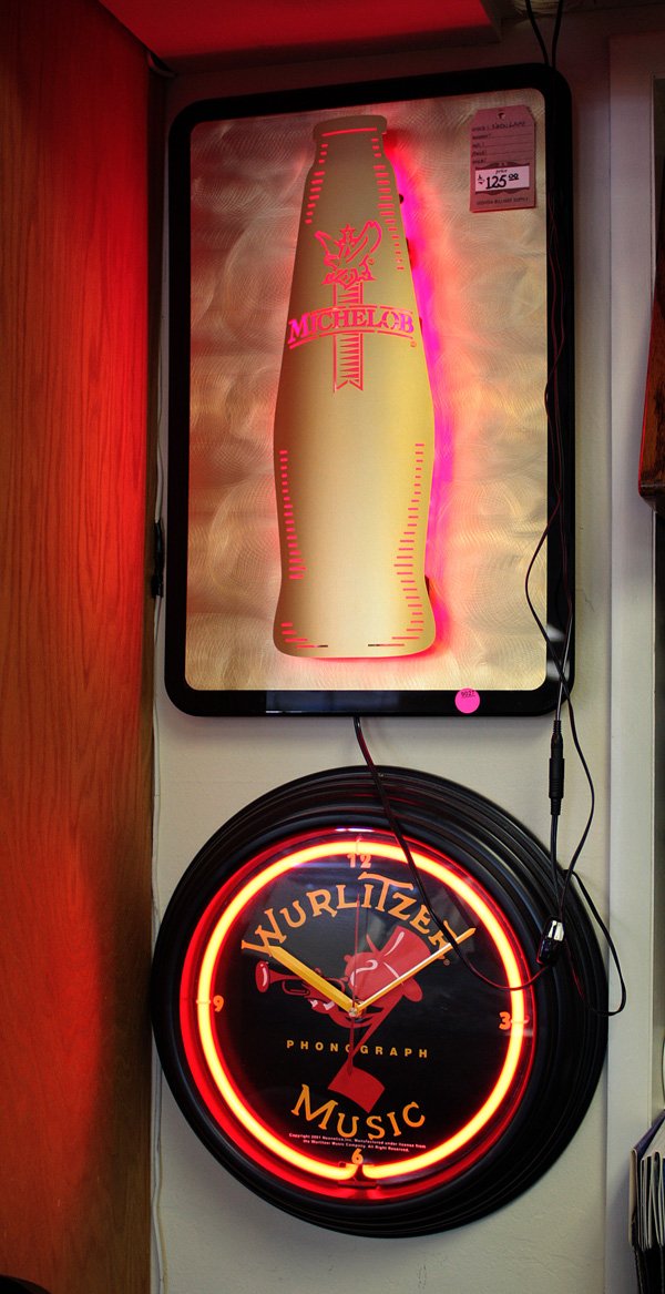 Michelob beer neon lamp and Wurlitzer Music clock: (lot of 3) Neon lamp advertising Michelob beer, a Wurlitzer Music clock, and a framed advertising for Ultra Shield All items must be paid for and picked up by 3 p.m. Thursday, May 14, 2009, no except