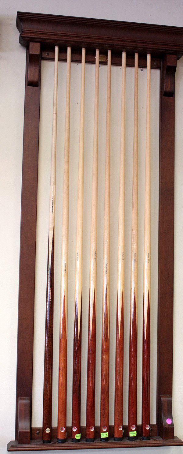 Mahogany finish Olhausen pool cue rack: Mahogany finish Oldhausen pool cue rack with eight cue slots together with seven Dufferin cues, 18oz and Sequoia Billiard Supply cue, 21oz all in multi-wood finishes All items must be paid for and pi