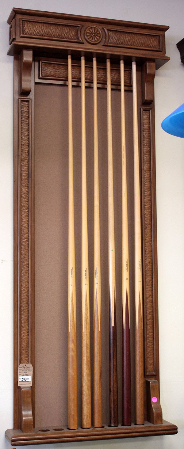 Thomas Aaron maple finish pool cue rack: Thomas Aaron maple finish pool cue rack with basketweave accents, solid tan colored felt back and eight cue slots together with six pool cues in multi-wood finishes, two 18oz, two 19oz & two 21oz All