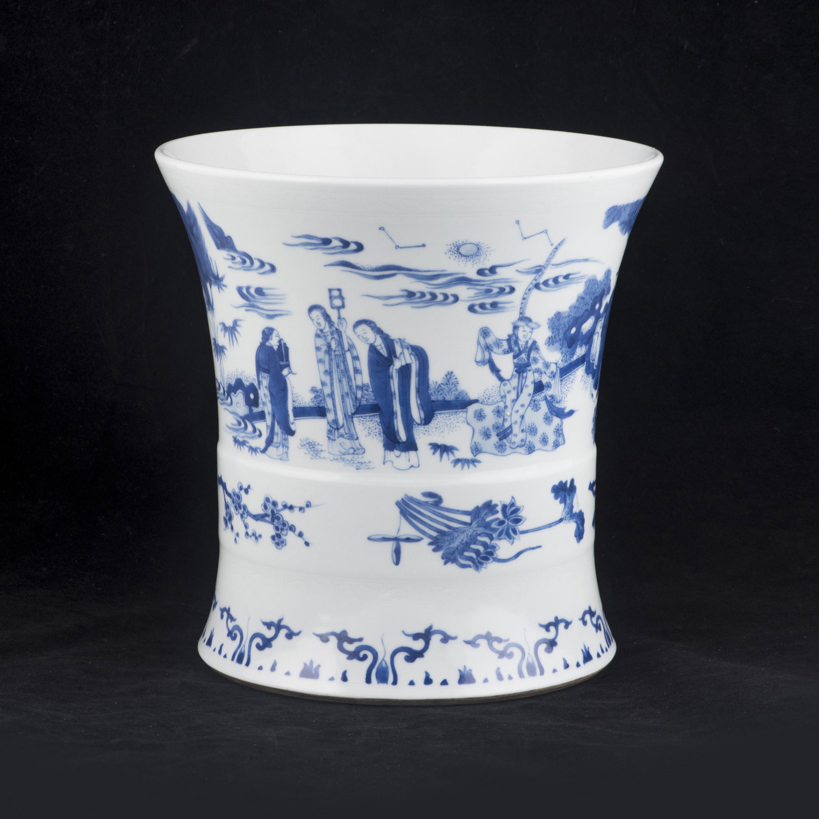 A Chinese blue and white brush pot: A Chinese blue and white brush pot, the waisted cylindrical form with a flaring rim, continuously decorated with court figures in an exterior courtyard setting, centering a raised collar decorated wit