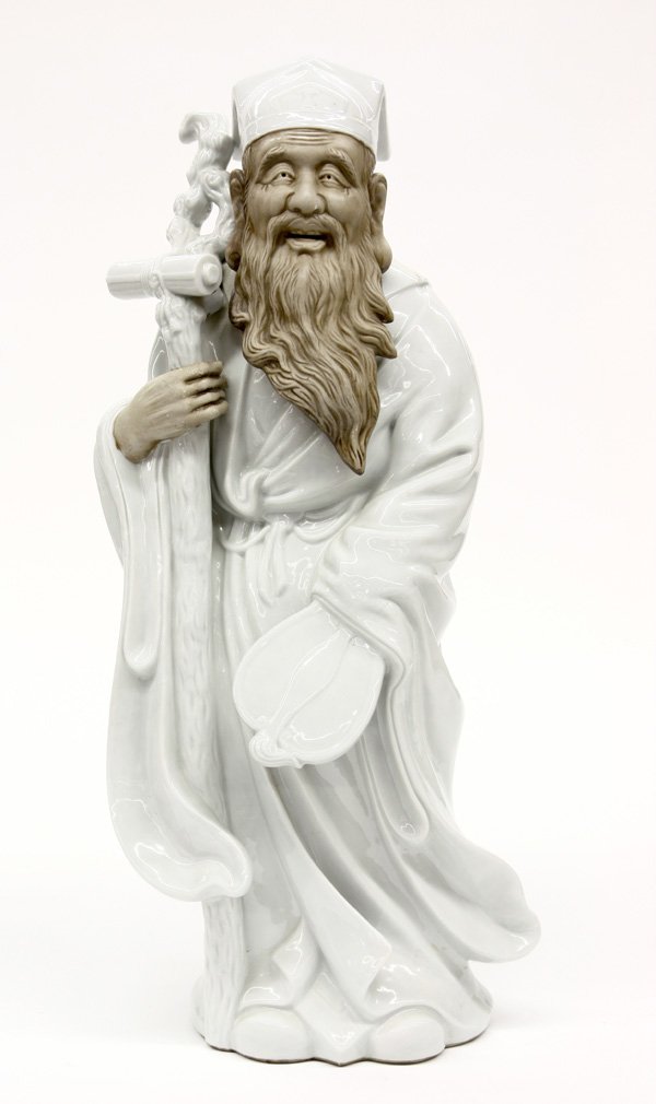 Kutani Ceramic Fukurokuju: Japanese large Kutani porcelain figure of Fukurokuju, 20th century, standing in long flowing robes with an uchiwa fan in one hand, the other grasping a gnarled staff suspending a scroll, the well-defi