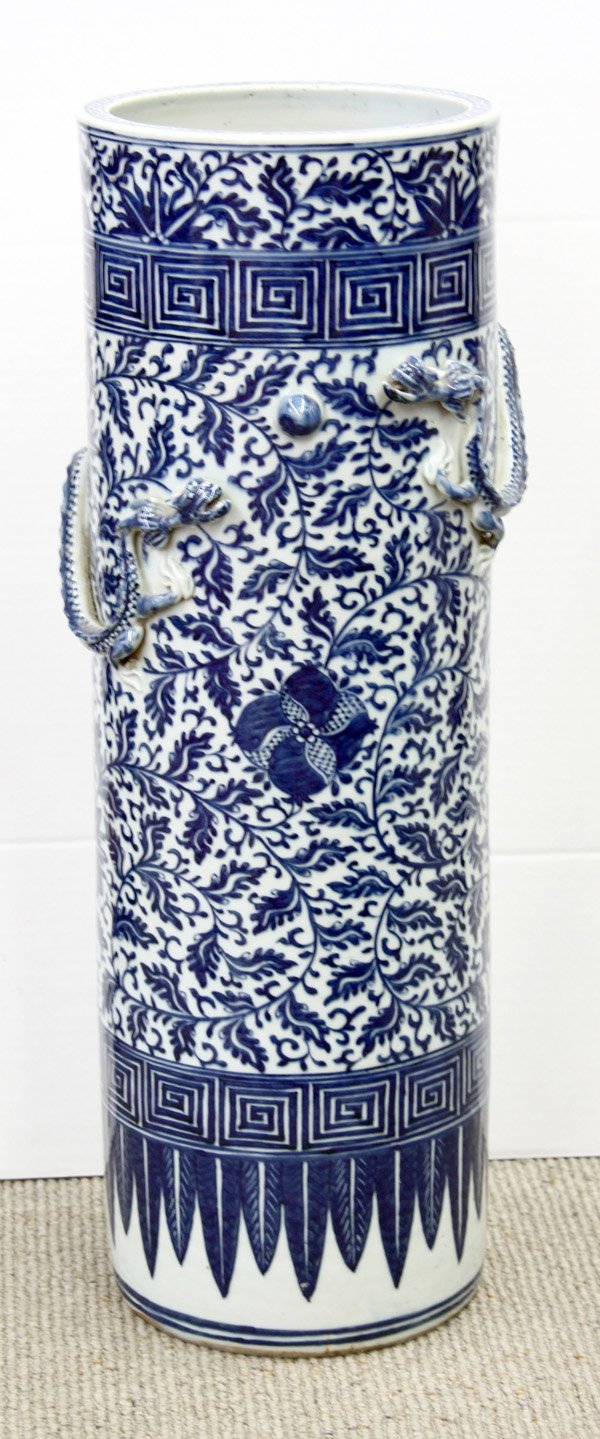 Chinese Blue-and-White Umbrella Stand: Chinese blue-and-white scroll/umbrella stand, the cyclindrical body painted with flowers and scrolling tendrils in underglaze blue, further decorated with two dragons in pursuit of a jewel beneath a k
