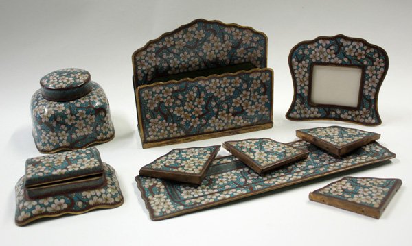 Chinese Cloisonne Desk Set, Prunus: (lot of 9) Chinese cloisonne enamel decorated desk set, of blooming pink prunus amid a turquoise ground, consisting of a letter holder, inkwell, stamp box, pen tray, a small frame and four blotter end