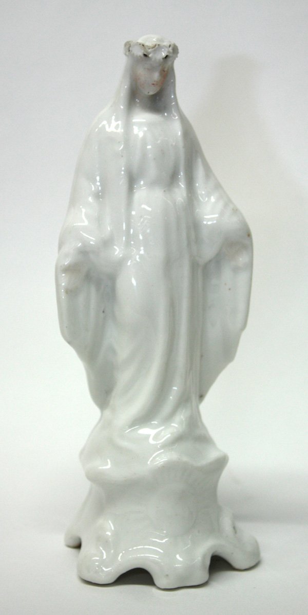 Porcelain Madonna figurine: Porcelain Madonna figurine, having draped clothing cascading from the wreath crown, the figure standing upon a base with impressed sunburst motif, 7''h