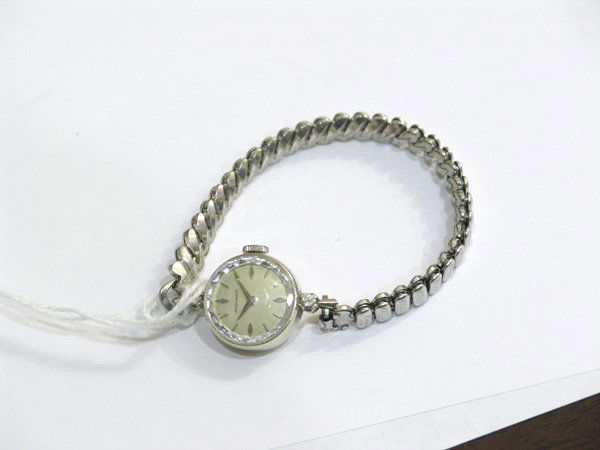 MOVADO wristwatch; mounted in 14k white gold: Ladies MOVADO wristwatch; mounted in 14k white gold, set with (2) round diamonds and expandible KEISLER stainless steel bracelet. Total wristwatch weight 14.6 grams.