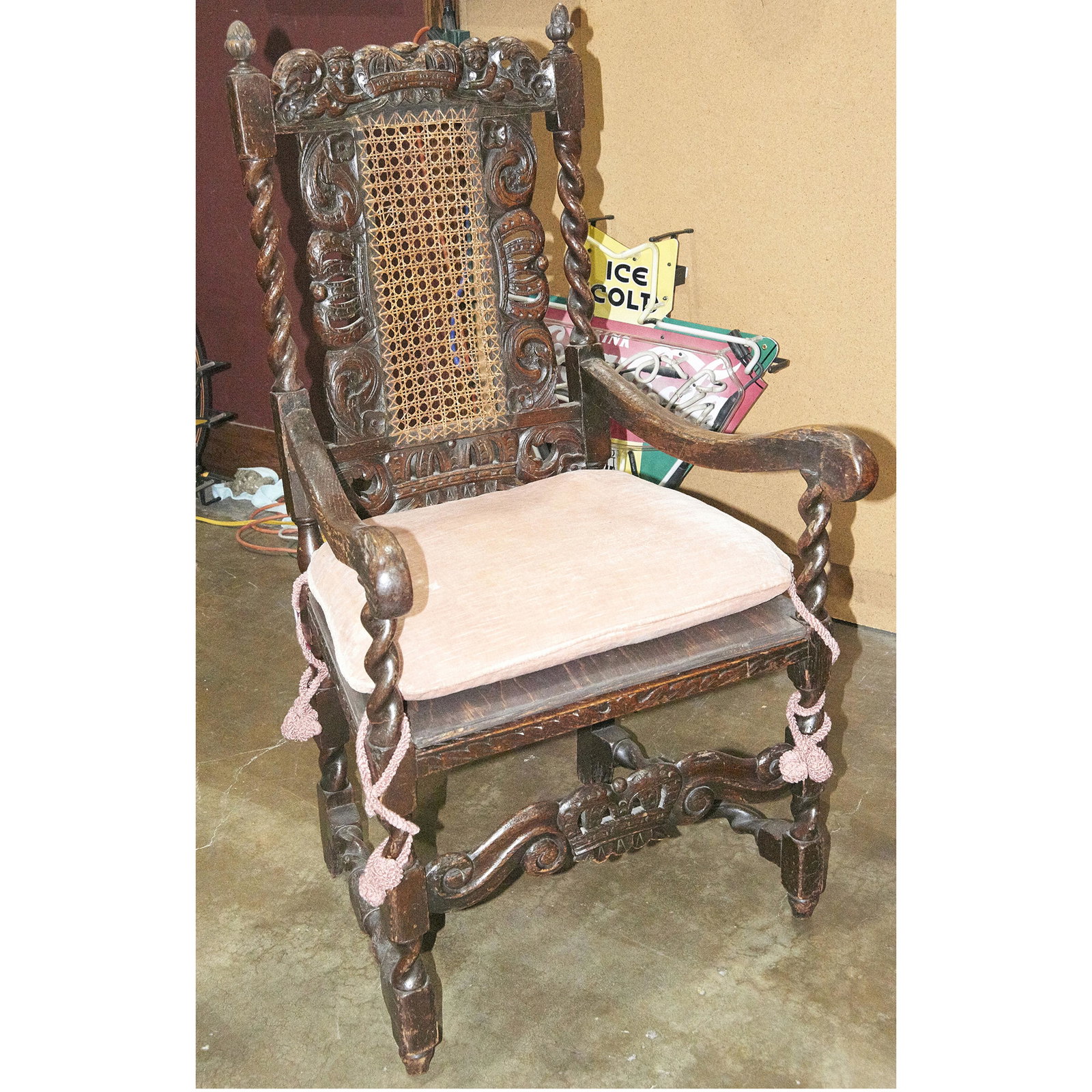 English walnut armchair likely late 17th century: English walnut armchair likely late 17th century, the highly carved crest centered with a shell medallion, above the cane back, flanked with barley twist supports, 45"h