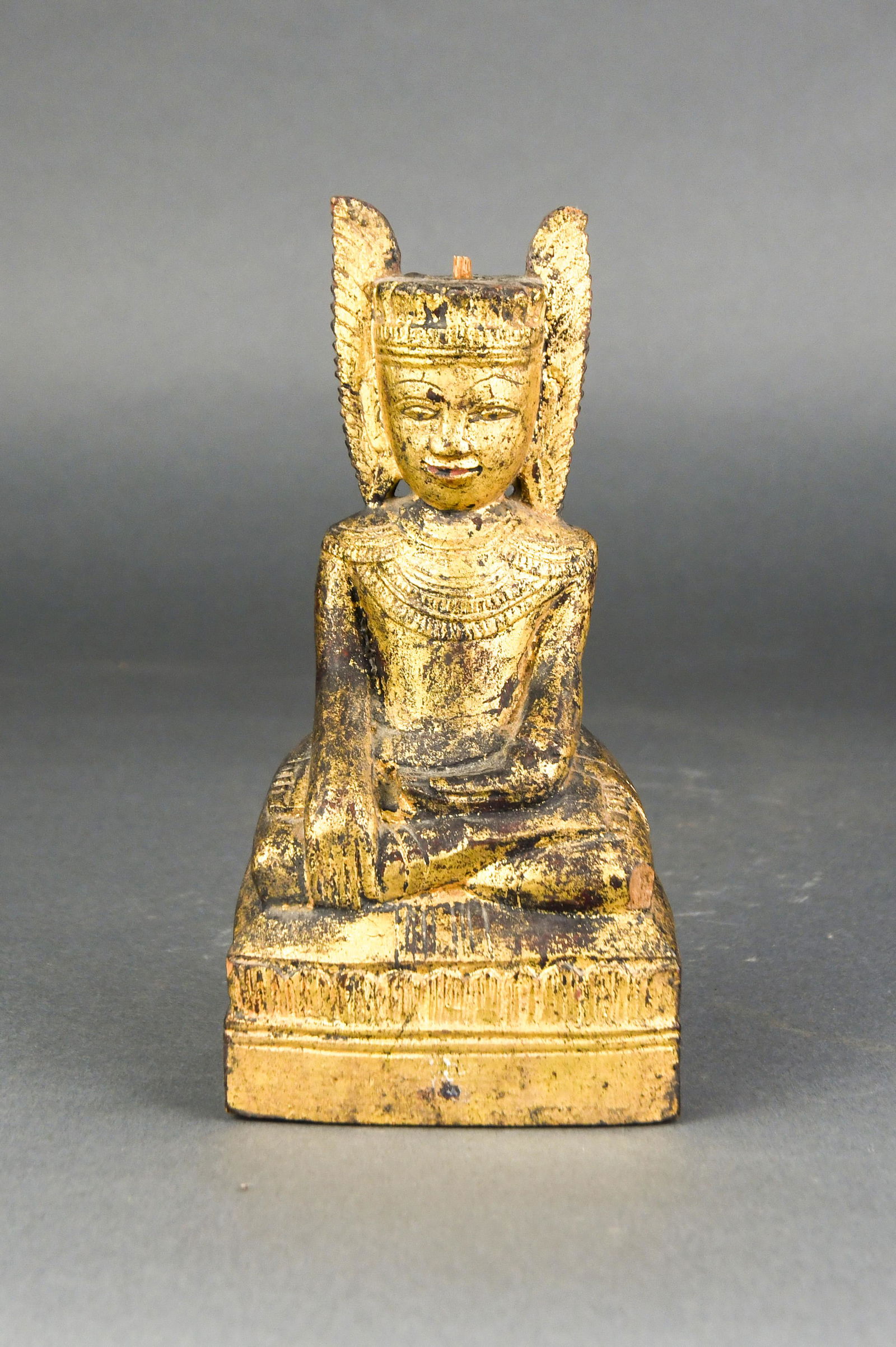 Southeast Asian giltwood figure of seated Buddha on a (1 of 3)