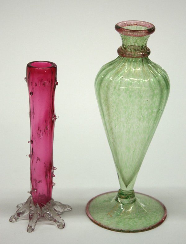 Venetian green glass bud vase: (lot of 2) Bud vases consisting of Venetian green glass with rose colored rim and neck, 7.5''h; and a Victorian cranberry glass with clear rigory and footed base (loss to one point), 6''h