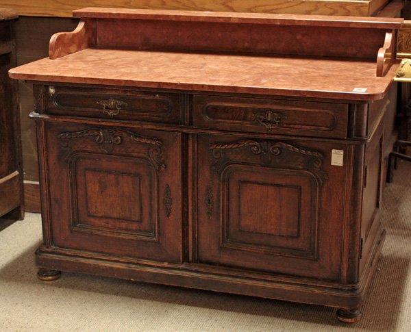 Louis Philippe carved walnut wash stand: Louis Philippe carved walnut rouge marble top wash stand/commode having two drawers over double door base with carved raised panels, rising on bun feet, 33''h x 44''w x 24''d