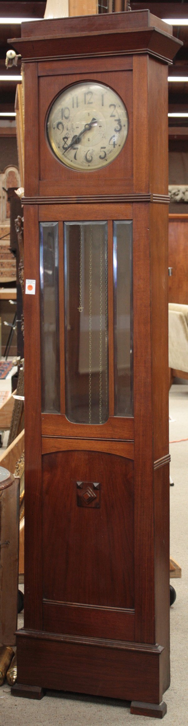 Gustav Becker arts and crafts cased tall clock: Gustav Becker walnut arts and crafts cased tall clock with silvered arabic numeral dial, weight driven eight-day time and strike movement, ''G B Universal'' gong plate, the case with three beveled gla