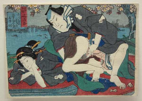 Japanese Erotic Woodblock Print, Utagawa School: Unframed Japanese shunga (erotic) woodblock print (koban yoko-e), an 'Edo meisho' (Famous Views of Edo) mitate, depicting a couple in an amorous adventure with a landscape in the background, unsigned 