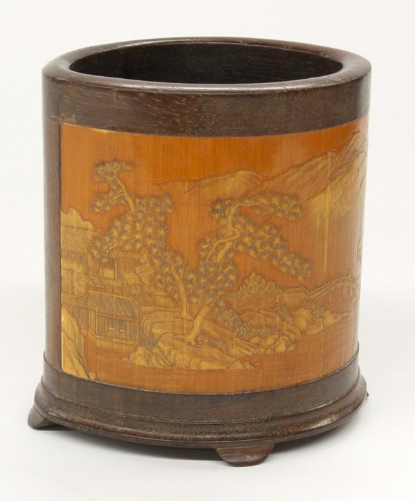 Chinese Bamboo Brushpot: Chinese mixed bamboo and wood brushpot, featuring two bamboo panels carved with mountain landscapes with one inscribed 'Wang Jie ke' (=carved by Wang Jie) followed by one small seal, all set into a ov