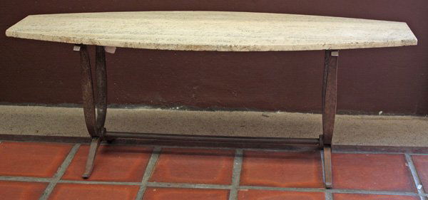 Cocktail table with travertine top: Cocktail table with travertine top on a wrought iron base, 20.5''h x 56''w x 20''d