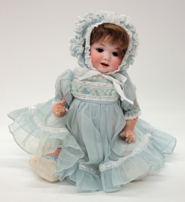 Vintage dolls: Armand Marseille bisque socket head character baby doll for George Borgfeldt & Company, circa 1913, decorated with hand painted facial features, brown sleep eyes, and an mouth with two lower teeth sho