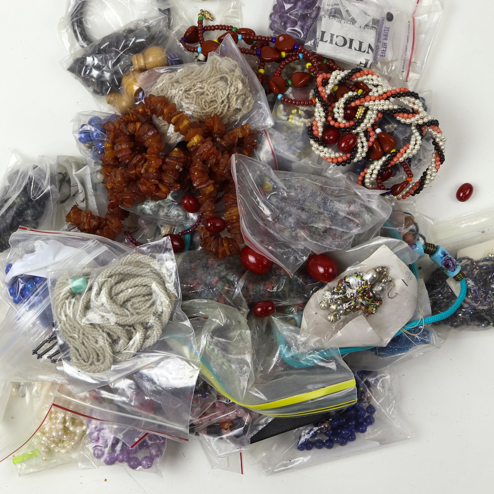 A group of hardstone jewelry: A group of hardstone jewelry including a lapis lazuli enameled bead necklace; an amethyst bead necklace with a carved pendant and etc.