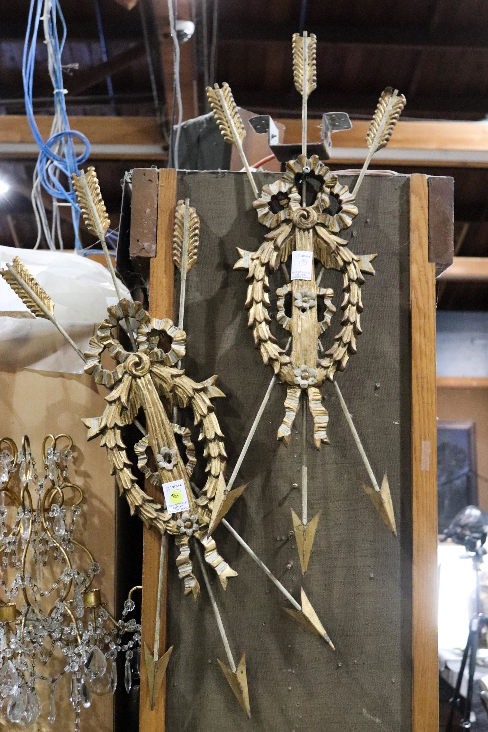 Pair of giltwood carved wall ornaments: Pair of giltwood carved wall ornaments, of wreath form with three arrows, 34"h x 12"w