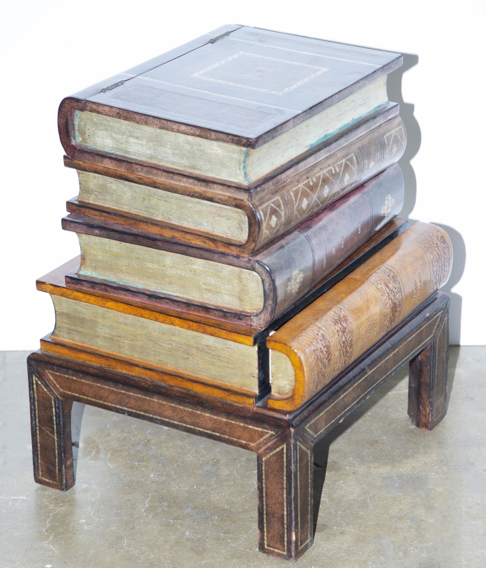 Maitland Smith stacking book form table on stand: Maitland Smith stacking book form table on stand fashioned as a safe, the sides with leather book spines, the cabinet lined in marbleized paper, 21"h 17"w x 15"d