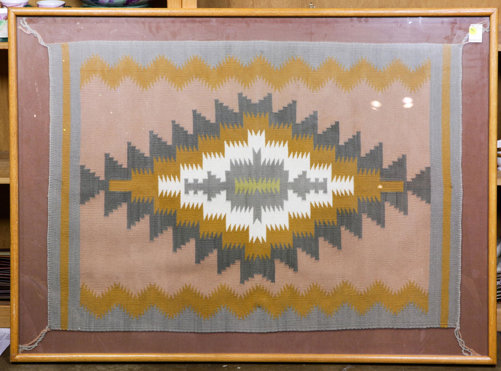 Navajo wool rug with peach ground, mounted in frame (1 of 1)