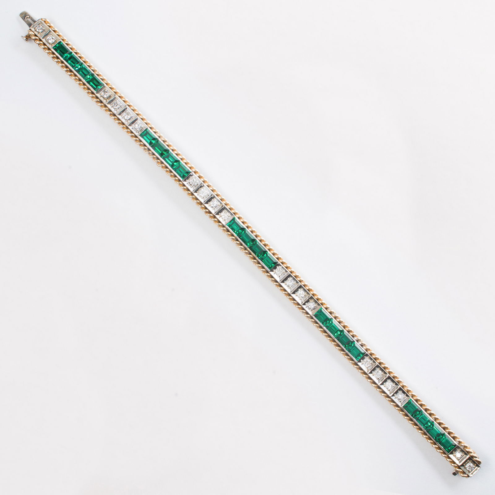 A diamond, synthetic emerald and fourteen karat gold (1 of 2)