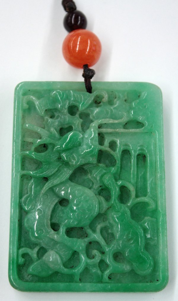 Chinese Jade/Jadeite Pendent, Phoenix: Chinese rectangular jade/jadeite plaque, carved with a writhing dragon amid scrolling tendrils and bat, reversed by a long tailed phoenix framed by leafy foliage, the apple-green matrix with light inc
