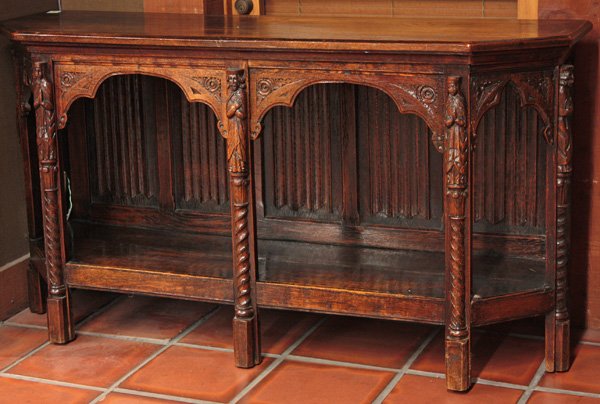 Spanish style carved oak credenza: 19th century Spanish style carved oak credenza with linenfold panel back, shaped aprons enhanced with corner rosettes and flanked with figural carvings atop barley twist columns, 32''h x 60''w x 17''d