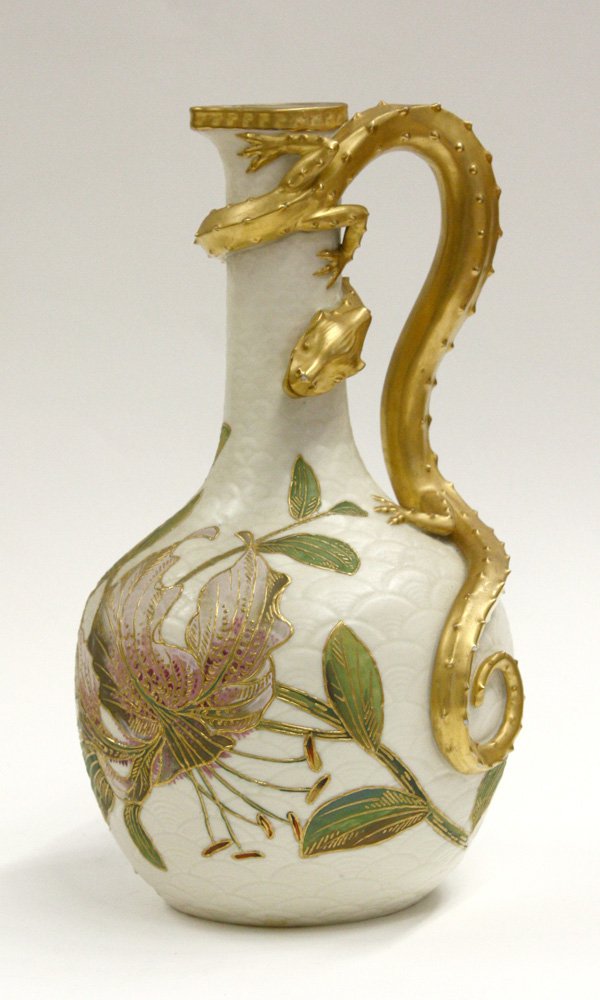 Royal Worcester dragon-handle ewer: Royal Worcester dragon-handle ewer, circa 1885, cream-colored body polychrome decorated with flowers with gilt highlights, applied with a molded dragon, 11''h, retail marking of Geo. Shreve, San Franc