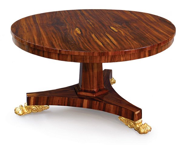 egency Palisander rosewood tilt top table: Regency Palisander rosewood tilt top breakfast table circa 1910 having octagonal tapered standard, quadruped base with carved gilt acanthus leaf claw feet, 29''h x 53''d. Provenance: The Merv Griffin 