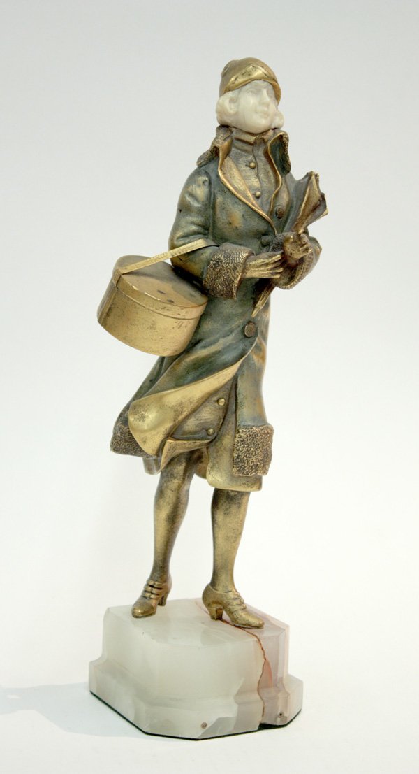 Rene Paul Marquet bronze statue: Bronze statue, by Rene Paul Marquet, modelled after a fashionable young woman with ivory face, gold patina, in cap and overcoat, holding a hat box, on marble base, signed 'MARQUET' to hat box, 12.5''h