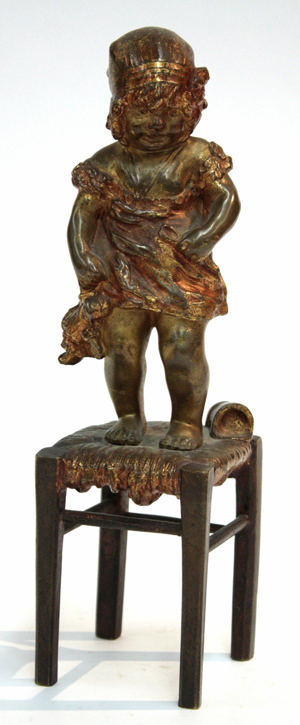 Bronze statue Juan Clara: Bronze statue, by Juan Clara (Spanish, 1875-1978), depicting a young girl standing on a stool while clutching her doll, with overall gold patina, impressed signature 'CLARA' to stool side, 8.5''h