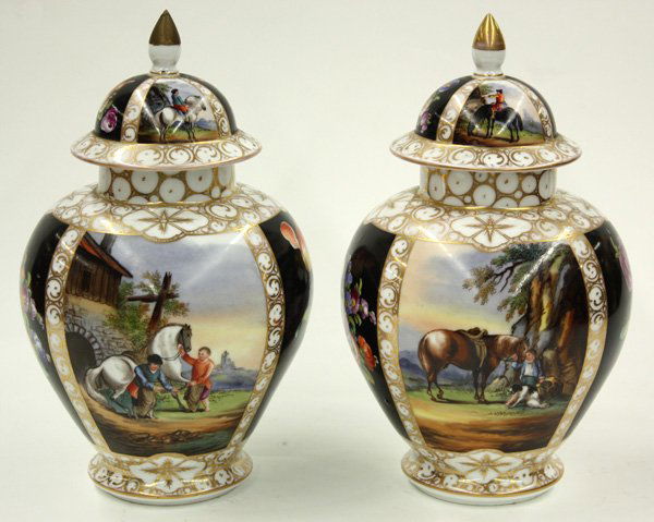 Pair of German mantel jars: Pair of German decorated covered mantel jars, featuring depictions of medieval scenes, 8''h x 6''d (repair to knop). Denver Art Museum Deaccession.