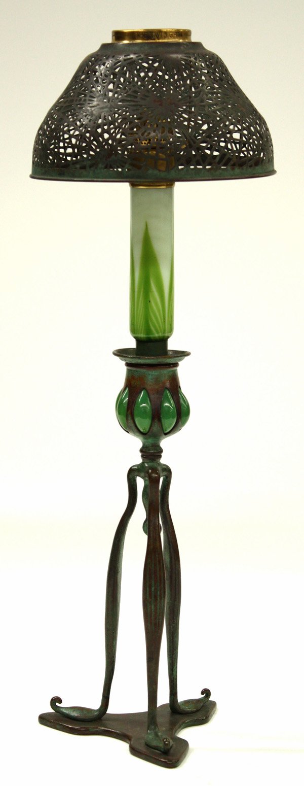 Tiffany Studios candle lamp: Tiffany Studios candle lamp with pine needle bronze shade, Favrile glass stem rising on trefoil patinated bronze base, stamped: ''Tiffany Studios, New York, 1212'', 18.5''h. Provenance: Purchased by F
