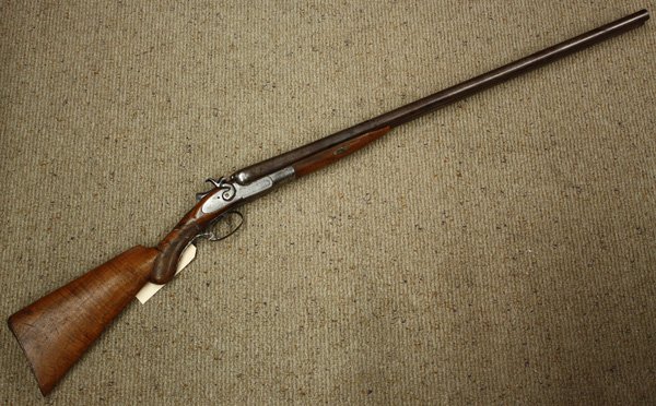 W. Richards 12 gauge shotgun circa 1860: W. Richards 12 gauge shotgun circa 1860, with laminated steel barrels and double hammer lock having floral engraving and game birds, 47''l overall (stock and trigger guard repaired)