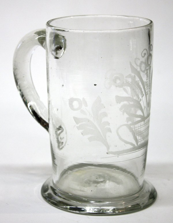 Stiegel type glass tankard: Stiegel type glass tankard with floral wheel etching having applied handle, 6''h. Denver Art Museum Deaccession.