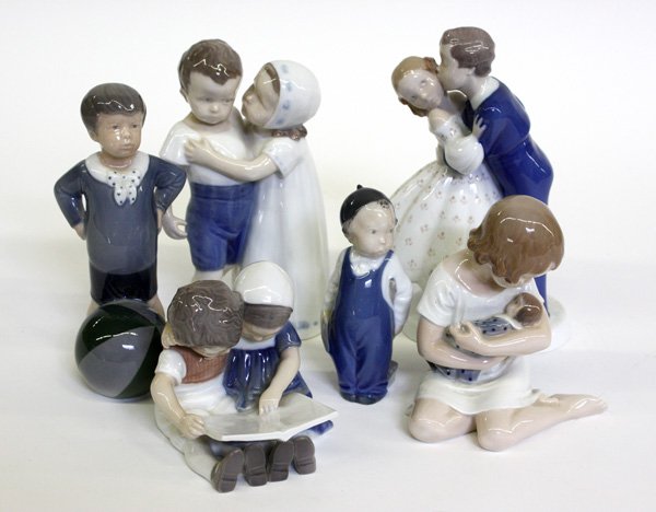 Danish porcelain figures, Royal Copenhagen figure: (lot of 6) Danish porcelain figures, three Bing and Grondahl figural groups including a girl hugging a boy, a young man kissing a girl on the cheek, and a pair of small children seated reading a book,