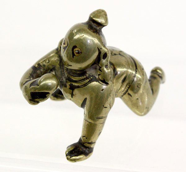 Indian Small Bronze Figure of Krisna: East Indian small bronze figurine of Krisna, 18th/19th century, cast as a crawling child with a ball of butter in his right hand, with inlaid eyes (extensive wear), 2.75''l; Provenance: Denver Art Mus