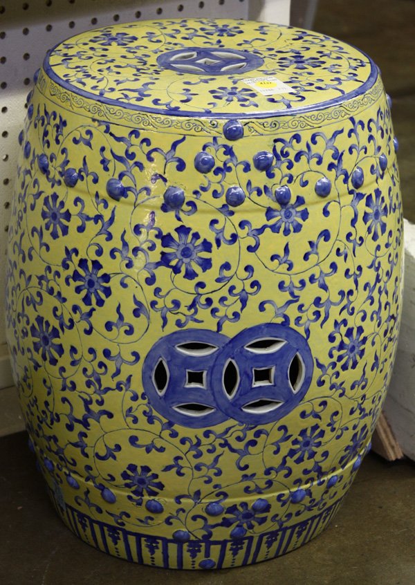 Chinese Underglaze Blue Decorated Yellow Stool: Chinese underglaze blue decorated porcelain garden seat, of drum form with a yellow ground meandered with scrolling tendrils and flowers, embellished by raised bosses and pierced cash emblems, 18''h