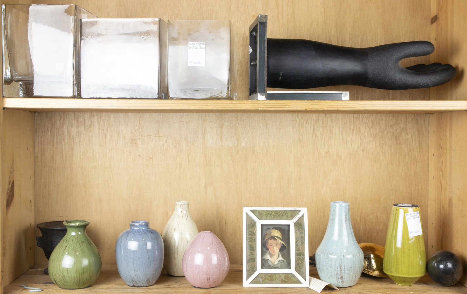 Two shelves of ceramic and glass vases: Two shelves of ceramic and glass vases, together with a large metal sculpture of a black rubber glove
