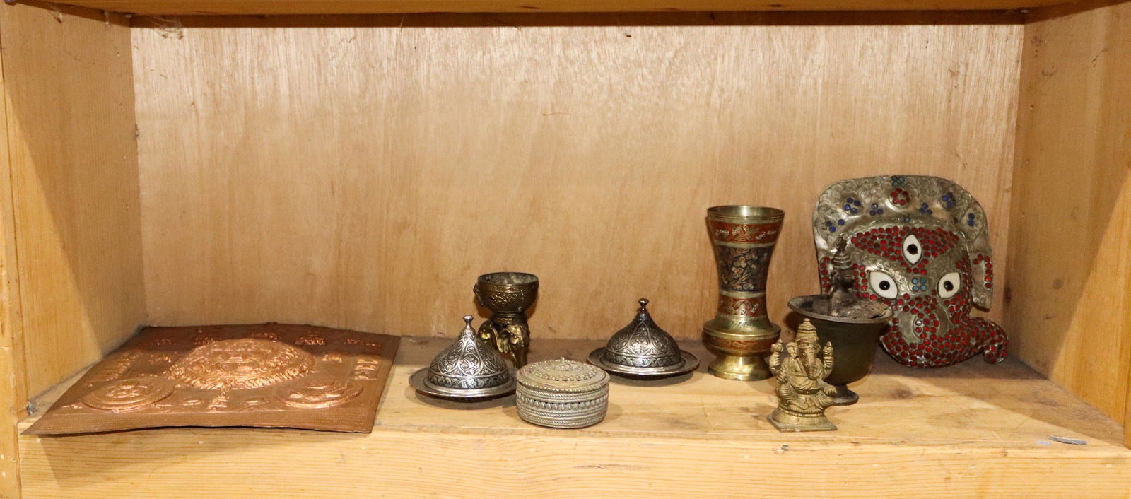 A shelf of Tibetan and Indian decorative items (1 of 1)