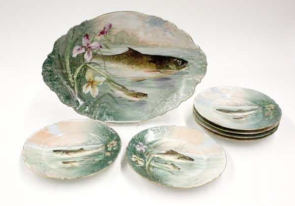 Limoges porcelain fish service: (lot of 7) Limoges porcelain fish service comprising serving platter and 6 individual plates, each featuring a unique hand painted scene with fishes and signed 'Tob'