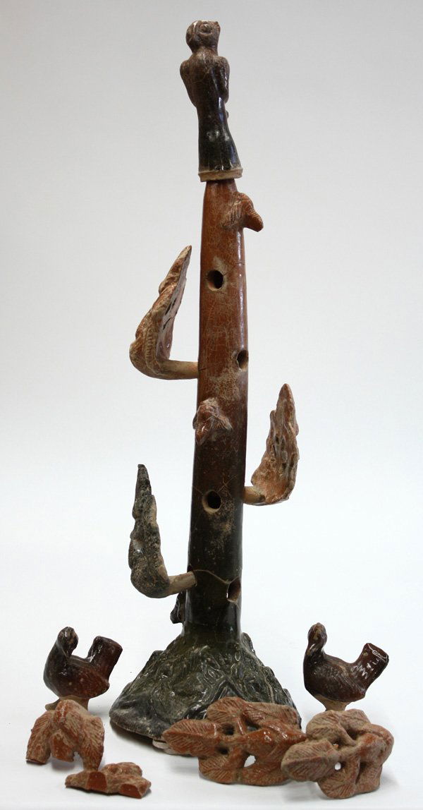 Chinese Red Pottery Model, Han Style: Chinese glazed red pottery model of a tree with birds, possibly Han dynasty, composed of a tall conical 'tree' issuing from a circular base molded with animals and figures amid stylized mountains, the