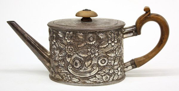 London sterling silver teapot by Edward Cooper: London sterling silver teapot by Edward Cooper, date mark corresponding to 1777, with inset flat lid having incised floral motif, wooden knop and scrolling handle, the elliptical cylinder body decorat