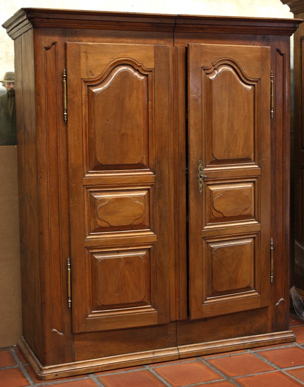 Louis XIV walnut armoire: Louis XIV walnut armoire having molded cornice, shaped and raised panelled double doors, 75''h x 60''w x 22''d (seamed in center for narrow staircase passage)