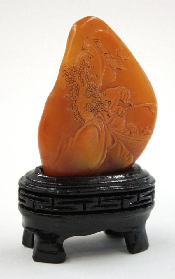 Soapstone Boulder Seal, Fishing: Chinese soapstone seal, the flat stone of natural configuration carved with a gentleman fishing on a boat, reversed by villa half hidden by a wooded cliff, base uncarved, all fashioned from a semi-tra