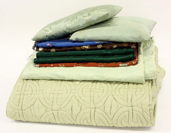 Chinese Textiles Fragments: (lot of 9) Group of Chinese textiles and bedding, the silk fabrics include a length with a blue ground scattered by woven flowers (approx 2.1 yards x 30''w), one of bamboo and prunus on a copper groun