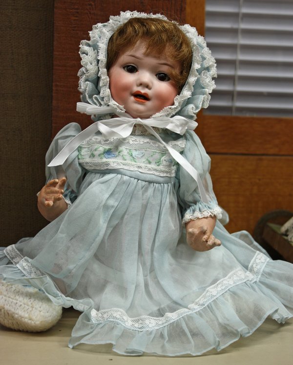 Vintage dolls: Armand Marseille bisque socket head character baby doll for George Borgfeldt & Company, circa 1913, decorated with hand painted facial features, brown sleep eyes, and an mouth with two lower teeth sho