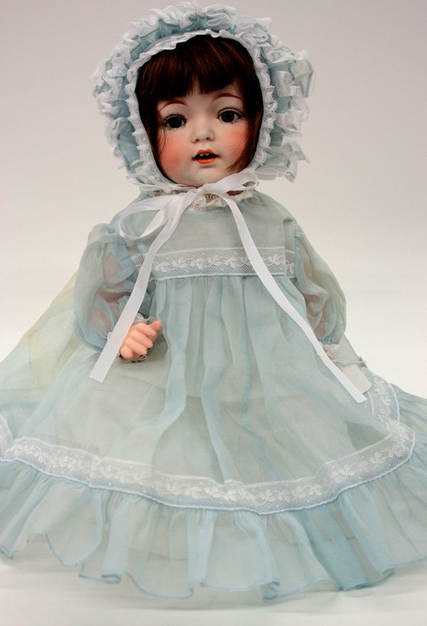 Vintage dolls: Fulper Pottery Company bisque socket head doll, circa 1918-1921, having hand decorated facial features, blue sleep eyes, and an open mouth showing two upper teeth and a molded tongue, on a compsition 