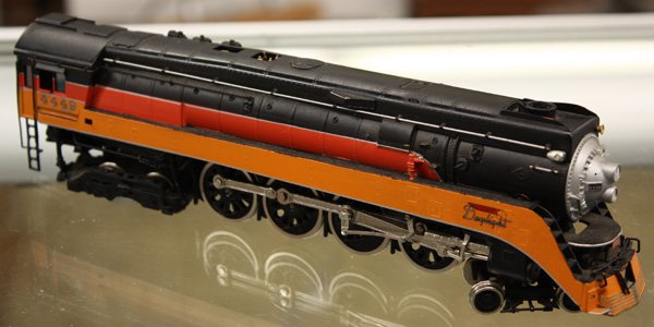 H0 scale Southern Pacific locomotive train set: (lot of 19) HO scale 13 piece Southern Pacific Daylight locomotive set, locomotive and 12 cars; together with 5 Canadian National HO scale cars, some wheels in associated box