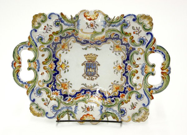 Platter, French faience 19th century: French faience platter, 19th century, having floral and acanthus leaf decoration throughout, with open double handles, the cartouche form base centered with crowned armorial crest with fleur-de-lys an