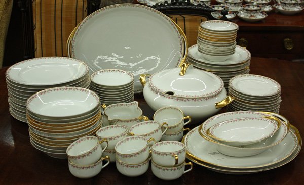 Haviland Limoges Porcelain Dinner Service: (lot of 79) Haviland Limoges China service for 12 with rose and gilt border, consisting of: 12 dinner plates; 12 salad plates; 12 dessert plates; 12 soup bowls; 12 cups & saucers; 12 dessert bowls; 3 