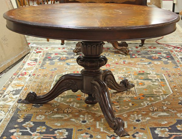 Viennese marquetry inlaid breakfast table: Viennese marquetry inlaid breakfast table having circular tilt top on carved and turned standard with quadruped base, 30''h x 51''d